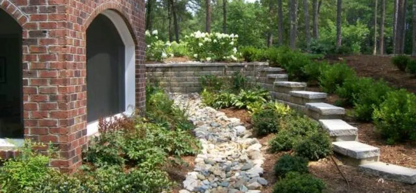 deco creek bed, in landscape, side of house